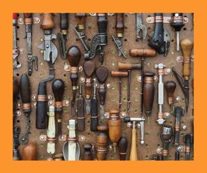 a wall of old woodworking tools